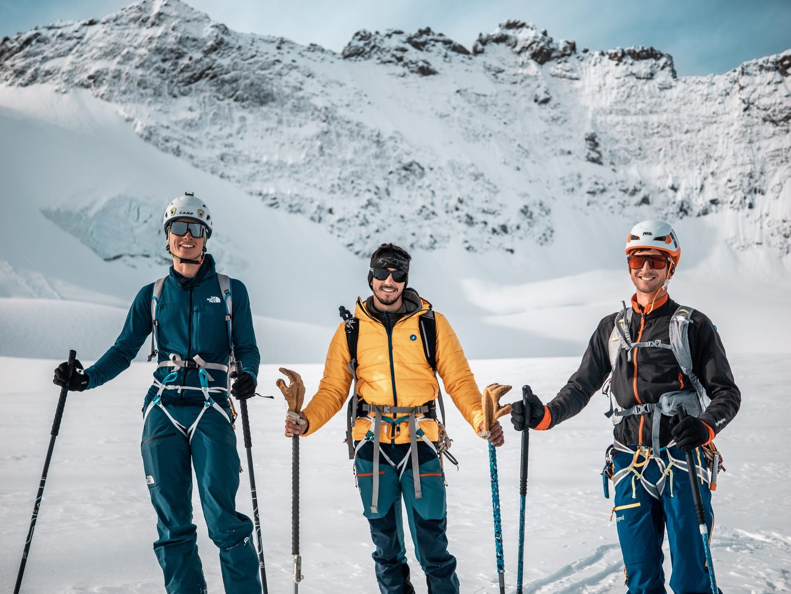 The three skiers, harnessed and helmeted, before the climb