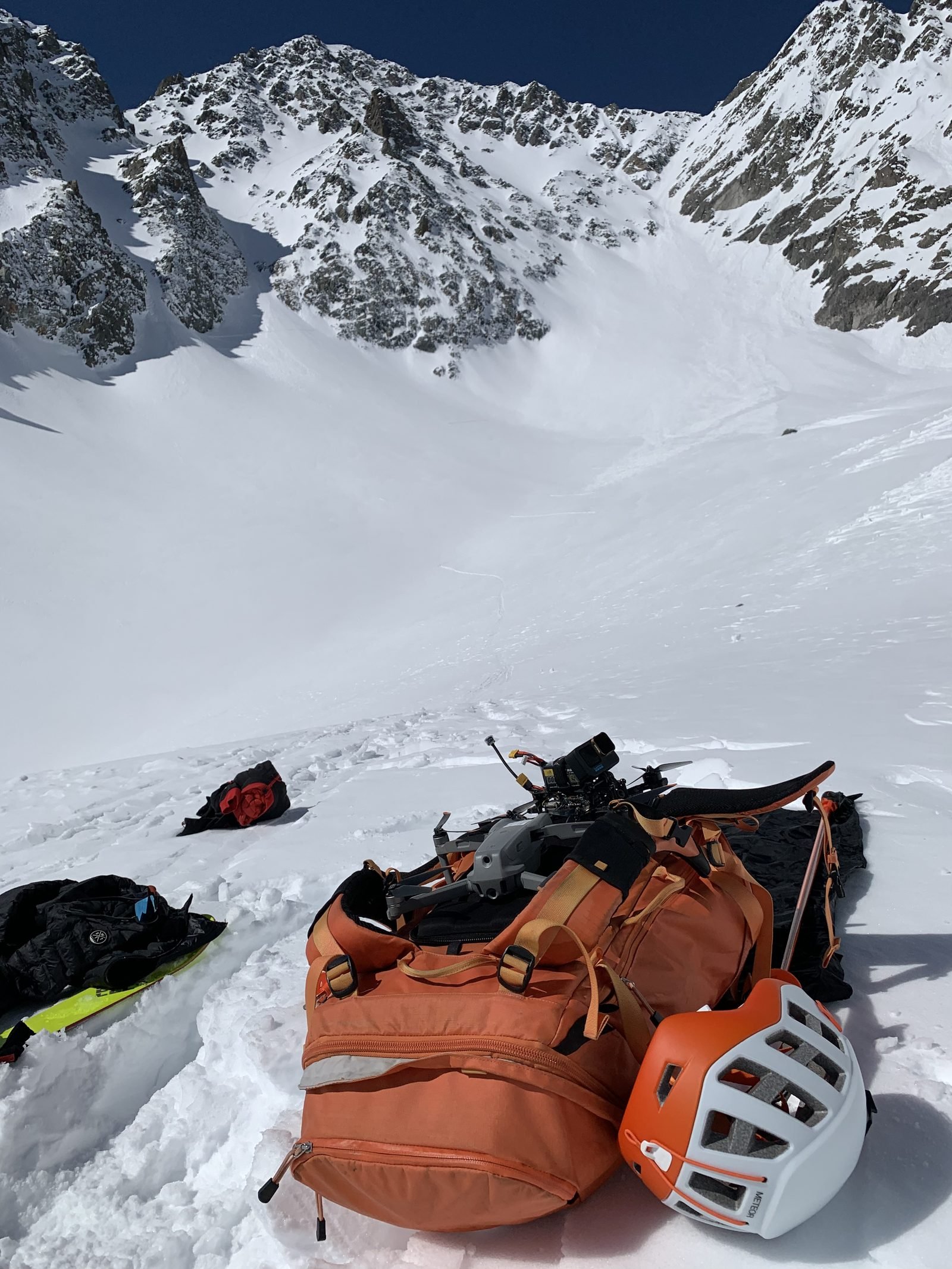 Bag, drone and helmet dropped in the snow below the couloir